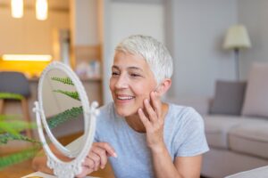 Senior Woman Looking in Mirror_Natural Aging_Senior Living Communities