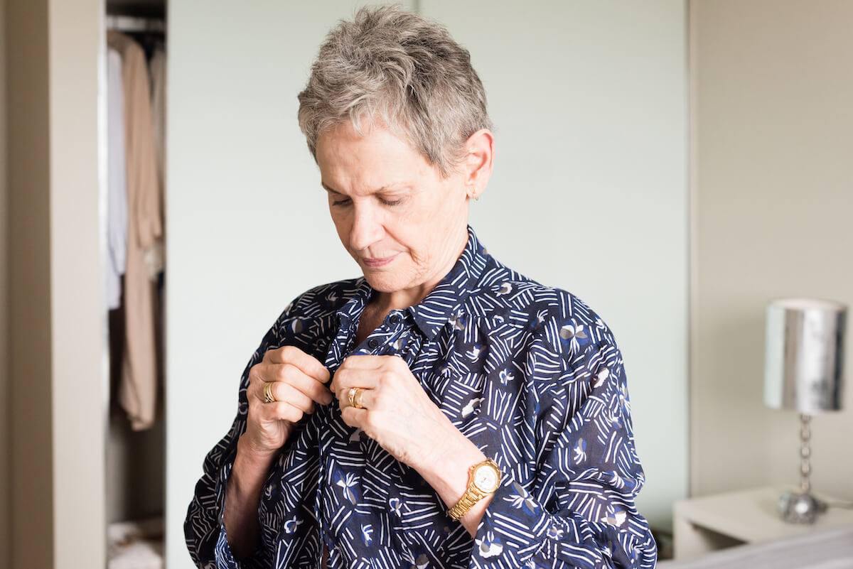 Older woman dressing herself