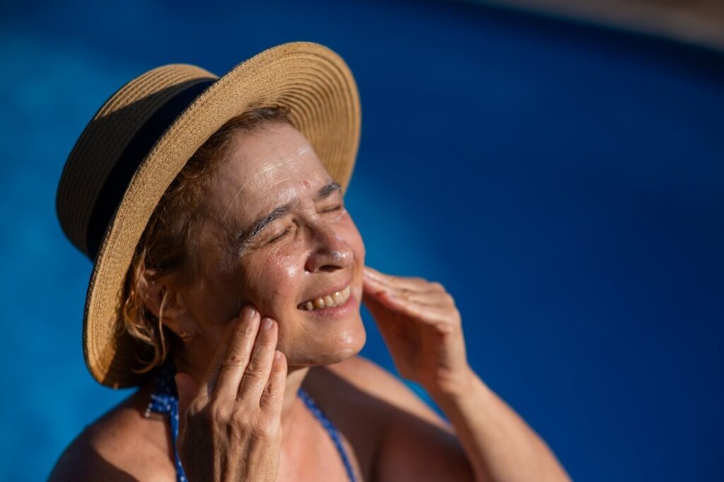 Older Woman Applying Herself Sunblock