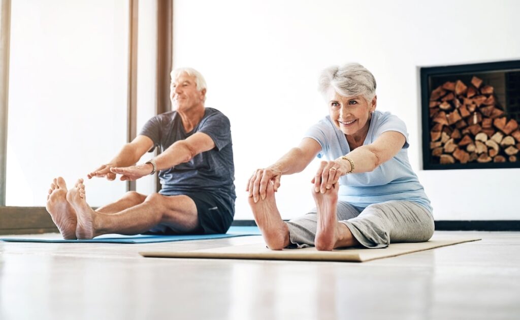 A couple of seniors stretching together