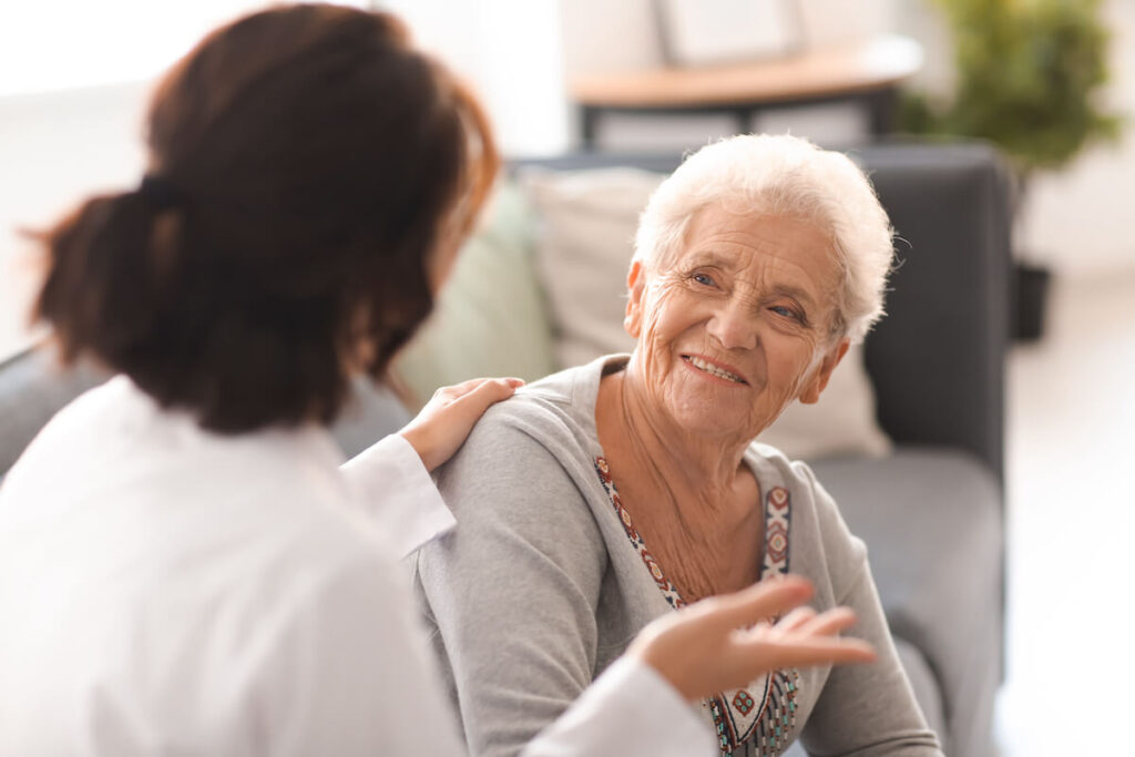 Caregiver talking to older woman