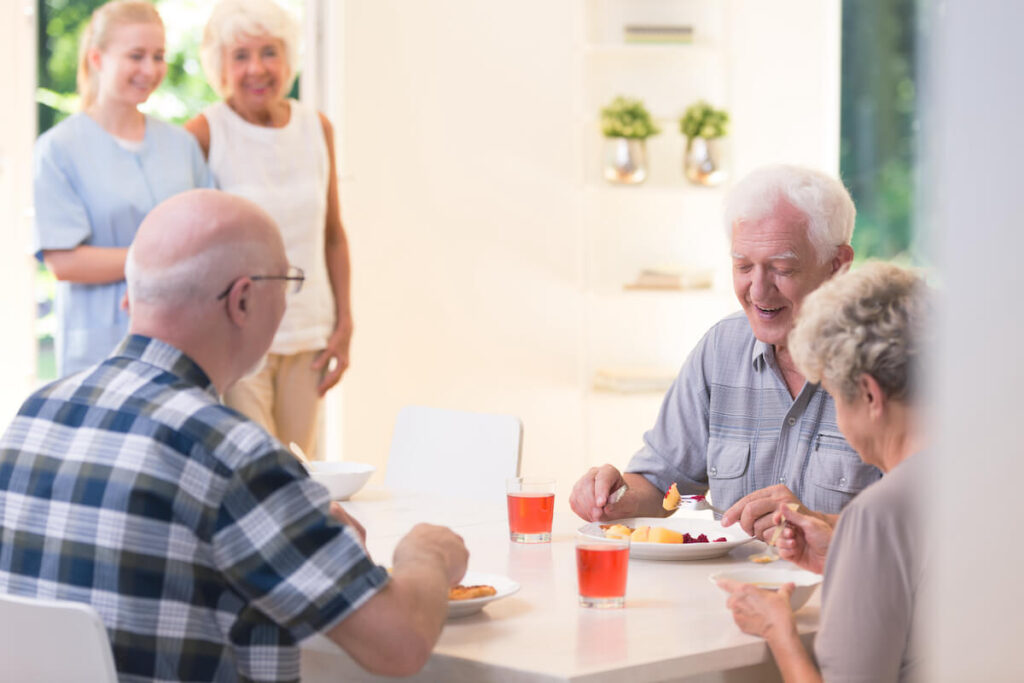 Seniors eating together at a community