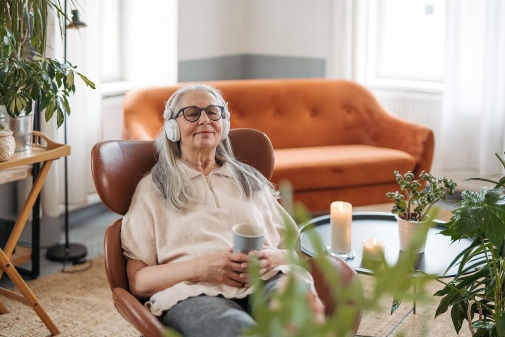 An older woman with dementia wearing headphones