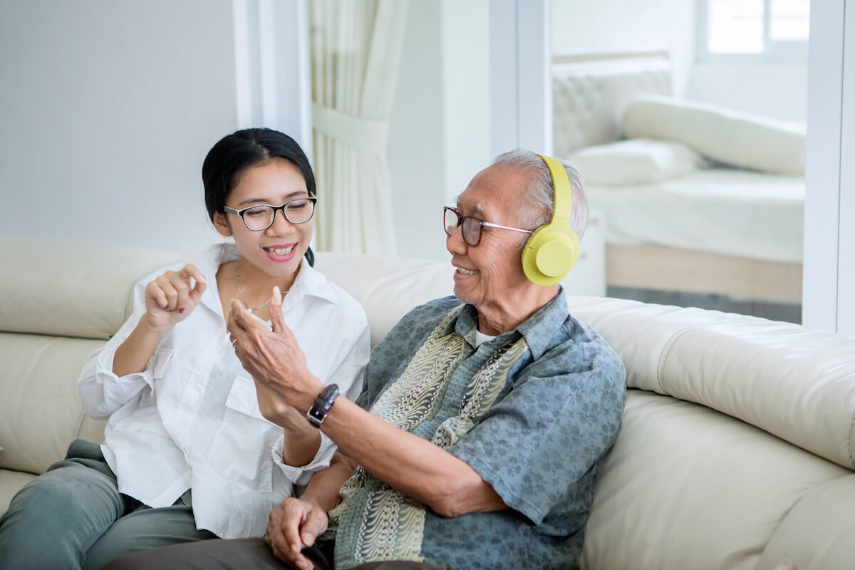An older man with headphones enjoying the benefits of music
