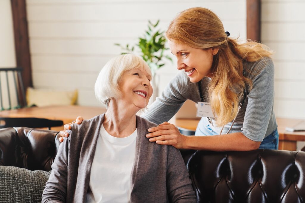 Caregiver supporting an older woman