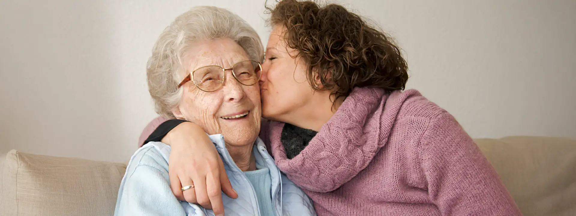 Daughter kissing mother