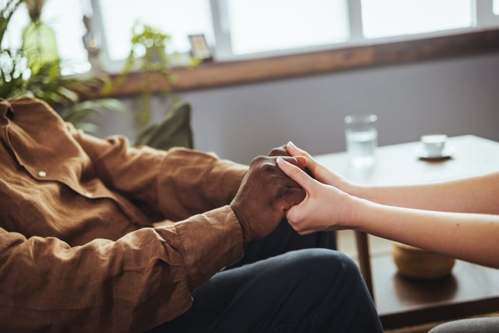 Woman holding an older man's hands