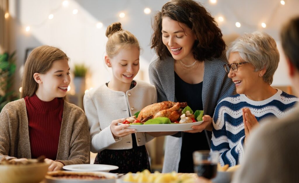 family with senior celebrates thanksgiving with turkey