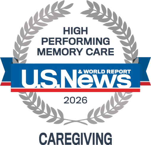 Award badge for US News & World Report 2026 High-Performing Memory Care, with a laurel wreath and blue ribbon reading 'Caregiving'